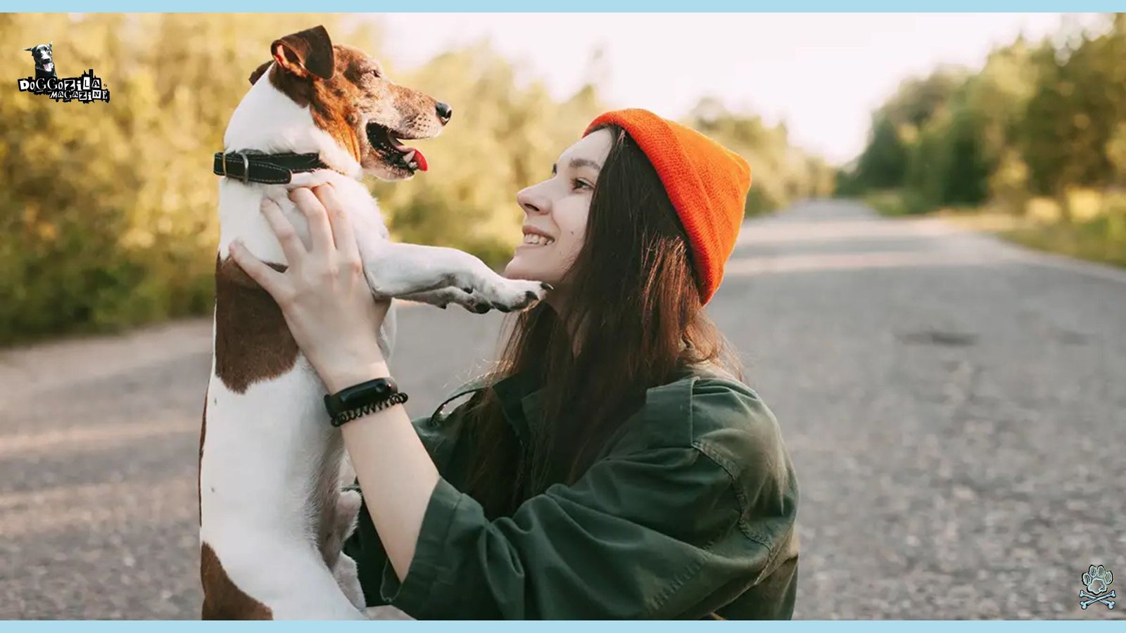 girl holding little puppy in the air