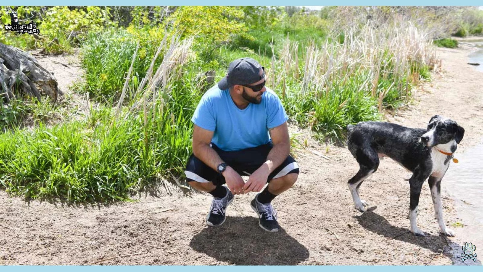 man squatting next his dog